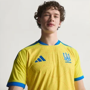 Areena Design <p>Cheer on Ukraine in the <strong>FIFA World Cup Ukraine 2026 Home Jersey</strong>. This jersey showcases Ukraine's vibrant national colors and crest, offering both style and comfort. Made with high-quality materials, it's the perfect choice for passionate fans looking to support their team in the 2026 World Cup with confidence and pride.</p> FIFA World Cup Ukraine 2026 Home Jersey <p>Cheer on Ukraine in the <strong>FIFA World Cup Ukraine 2026 Home Jersey</strong>. This jersey showcases Ukraine's vibrant national colors and crest, offering both style and comfort. Made with high-quality materials, it's the perfect choice for passionate fans looking to support their team in the 2026 World Cup with confidence and pride.</p>