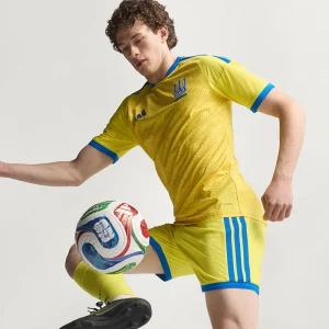 Areena Design <p>Cheer on Ukraine in the <strong>FIFA World Cup Ukraine 2026 Home Jersey</strong>. This jersey showcases Ukraine's vibrant national colors and crest, offering both style and comfort. Made with high-quality materials, it's the perfect choice for passionate fans looking to support their team in the 2026 World Cup with confidence and pride.</p> FIFA World Cup Ukraine 2026 Home Jersey <p>Cheer on Ukraine in the <strong>FIFA World Cup Ukraine 2026 Home Jersey</strong>. This jersey showcases Ukraine's vibrant national colors and crest, offering both style and comfort. Made with high-quality materials, it's the perfect choice for passionate fans looking to support their team in the 2026 World Cup with confidence and pride.</p>