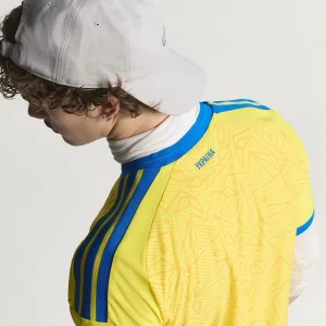 Areena Design <p>Cheer on Ukraine in the <strong>FIFA World Cup Ukraine 2026 Home Jersey</strong>. This jersey showcases Ukraine's vibrant national colors and crest, offering both style and comfort. Made with high-quality materials, it's the perfect choice for passionate fans looking to support their team in the 2026 World Cup with confidence and pride.</p> FIFA World Cup Ukraine 2026 Home Jersey <p>Cheer on Ukraine in the <strong>FIFA World Cup Ukraine 2026 Home Jersey</strong>. This jersey showcases Ukraine's vibrant national colors and crest, offering both style and comfort. Made with high-quality materials, it's the perfect choice for passionate fans looking to support their team in the 2026 World Cup with confidence and pride.</p>