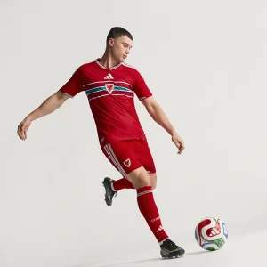 Areena Design <p>Cheer on your team in style with the <strong>FIFA World Cup Wales 2026 Home Authentic Jersey</strong>. Featuring an iconic design inspired by Wales’ legendary home look, this jersey combines a lightweight feel and athletic fit, perfect for match days, training, or everyday fan wear.</p> FIFA World Cup Wales 2026 Home Authentic Jersey <p>Cheer on your team in style with the <strong>FIFA World Cup Wales 2026 Home Authentic Jersey</strong>. Featuring an iconic design inspired by Wales’ legendary home look, this jersey combines a lightweight feel and athletic fit, perfect for match days, training, or everyday fan wear.</p>
