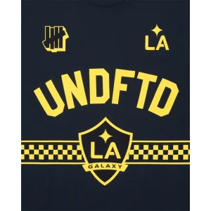 Areena Design <p>UNDEFEATED X USSF X MLS LA GALAXY TEE delivers graphic fan style with easy everyday wearability, inspired by U.S. Soccer federation culture and LA Galaxy supporter culture. A versatile tee for match days, streetwear looks, travel and everyday casual wear.</p> UNDEFEATED X USSF X MLS LA GALAXY TEE <p>UNDEFEATED X USSF X MLS LA GALAXY TEE delivers graphic fan style with easy everyday wearability, inspired by U.S. Soccer federation culture and LA Galaxy supporter culture. A versatile tee for match days, streetwear looks, travel and everyday casual wear.</p>