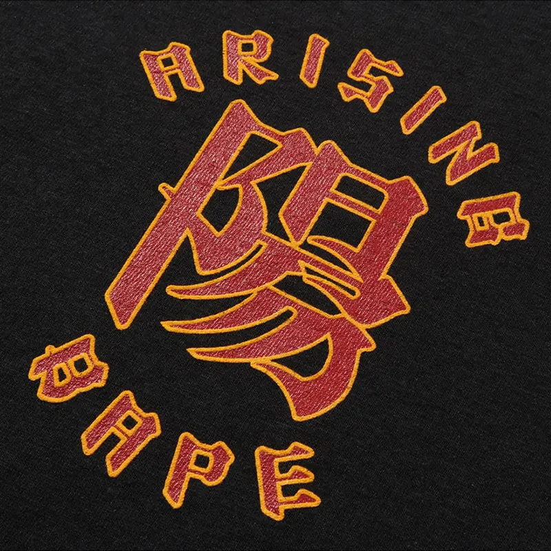 A RISING BAPE Black Tee 2 A RISING BAPE Black Tee <p><strong>A RISING BAPE Black Tee</strong> delivers a casual statement t-shirt look for streetwear outfits, relaxed days, travel, and everyday wear. Its distinctive design offers easy outfit pairing, versatile styling, and standout graphic appeal, making it a strong choice for personal wardrobes, collections, or gifting.</p>