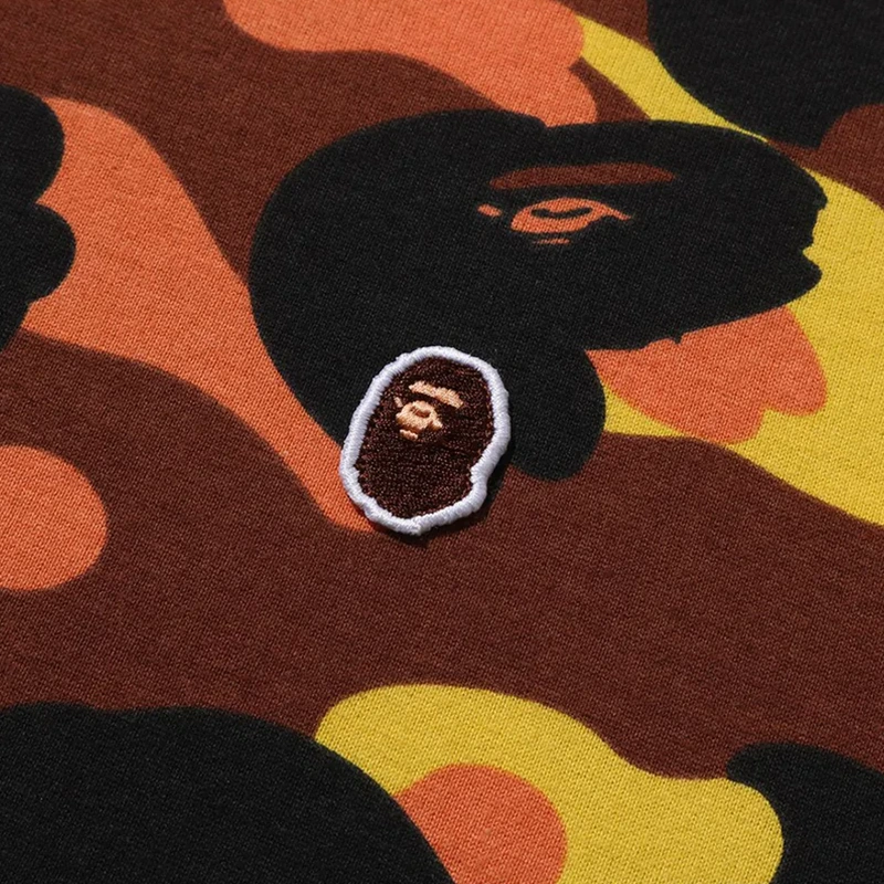 BAPE 1ST Orange Camo One Point Tee 2 BAPE 1ST Orange Camo One Point Tee <p><strong>BAPE 1ST Orange Camo One Point Tee</strong> delivers a casual statement t-shirt look for streetwear outfits, relaxed days, travel, and everyday wear. Its distinctive design offers easy outfit pairing, versatile styling, and standout graphic appeal, making it a strong choice for personal wardrobes, collections, or gifting.</p>