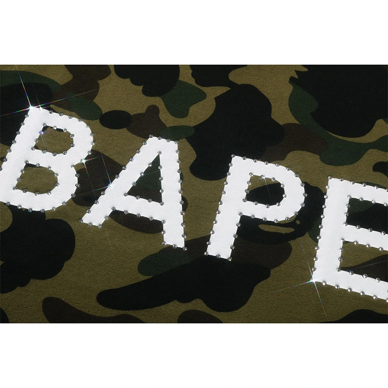 BAPE 1st Camo Rhinestone Tee BAPE 1st Camo Rhinestone Tee <p><strong>BAPE 1st Camo Rhinestone Tee</strong> delivers a casual statement t-shirt look for streetwear outfits, relaxed days, travel, and everyday wear. Its distinctive design offers easy outfit pairing, versatile styling, and standout graphic appeal, making it a strong choice for personal wardrobes, collections, or gifting.</p>