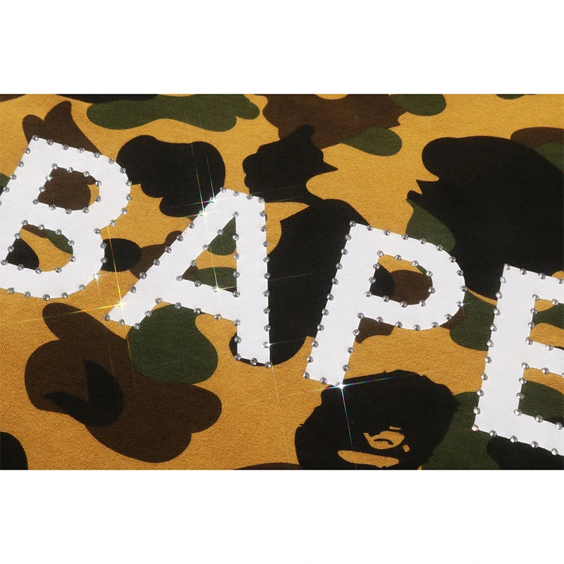 BAPE Yellow 1st Camo Rhinestone Tee BAPE Yellow 1st Camo Rhinestone Tee <p><strong>BAPE Yellow 1st Camo Rhinestone Tee</strong> delivers a casual statement t-shirt look for streetwear outfits, relaxed days, travel, and everyday wear. Its distinctive design offers easy outfit pairing, versatile styling, and standout graphic appeal, making it a strong choice for personal wardrobes, collections, or gifting.</p>