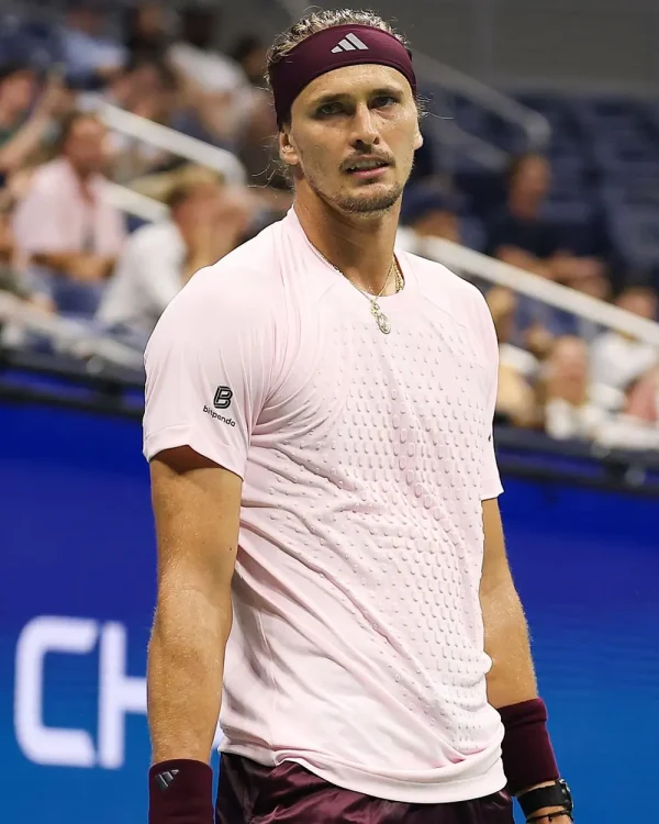 Alexander-Zverev-2026-US-Open-Day-5-T-Shirt Alexander Zverev 2026 US Open Day 5 T-Shirt <strong>Product Specifications:</strong> <ul> <li>Material: Polyester</li> <li>Collar: Round Neck</li> <li>Sleeves: Short Sleeves</li> <li>Hem: Straight Athletic Hem</li> <li>Closure: Pullover</li> <li>Color: Pale Pink</li> </ul>